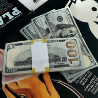 old fake money over playboy magazines