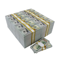 Stacks of prop money designed to look like US $100 bills, bundled with rubber bands and placed on a white surface.