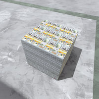 cube of prop money over a marble floor