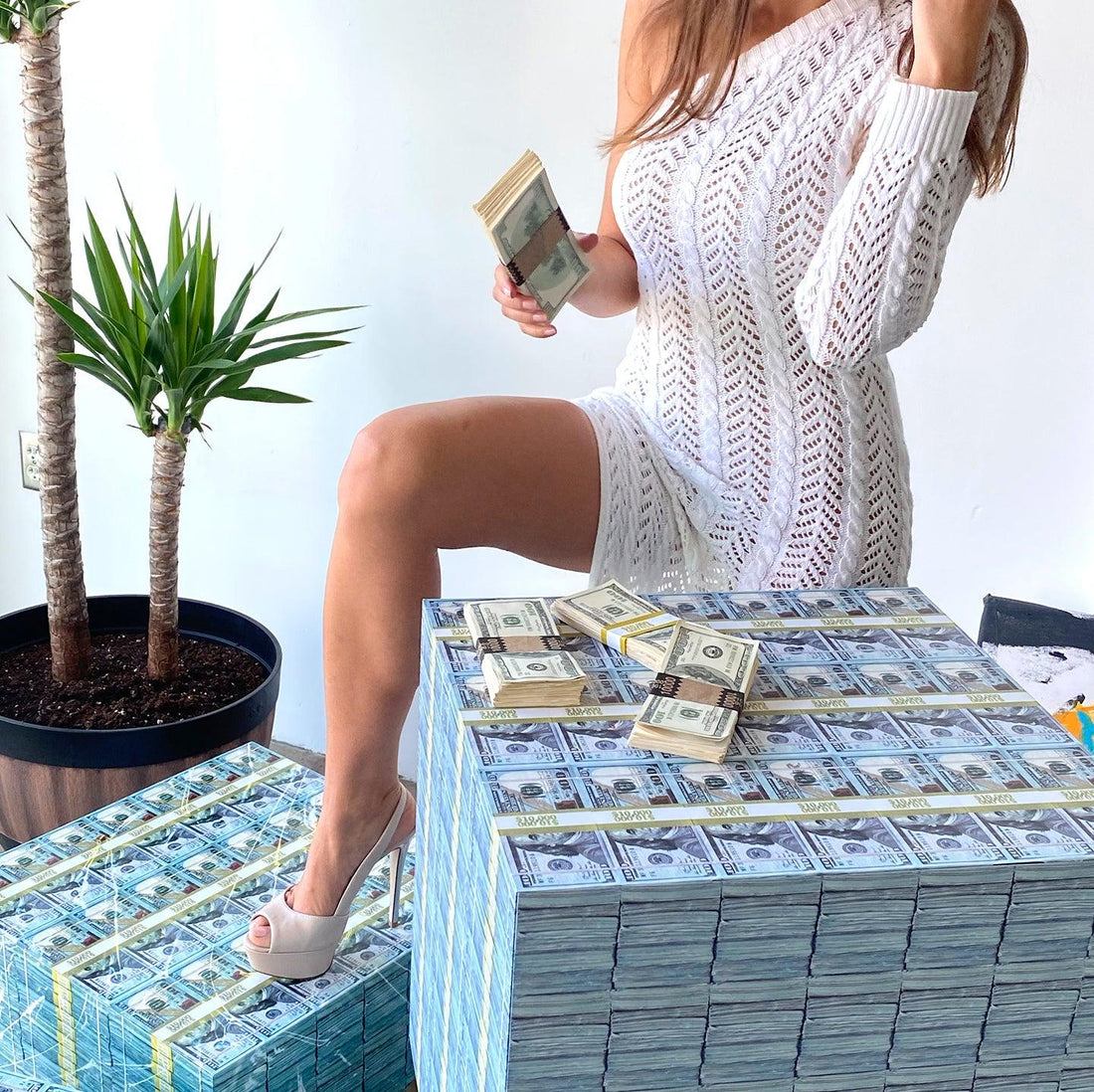 woman with white dress and money tables