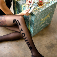woman on floor with leggings and money table