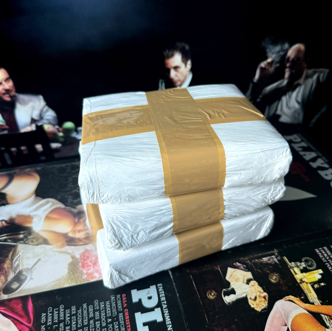 Wrapped film-set display bricks beside wall art