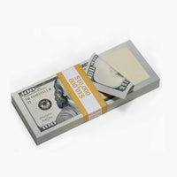 Stack of U.S. hundred-dollar bills with a yellow ribbon on a white background
