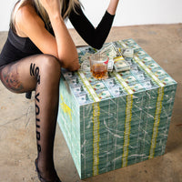 woman with leggings not yours over a money table with whiskey and prop money in loft studio