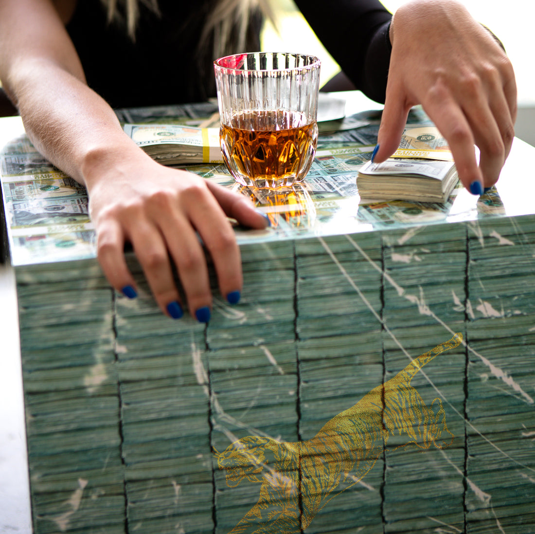 money coffee table with whiskey and prop money