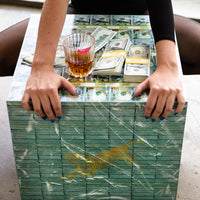 money table with woman hand over and a tiger stamp whiskey and prop money 